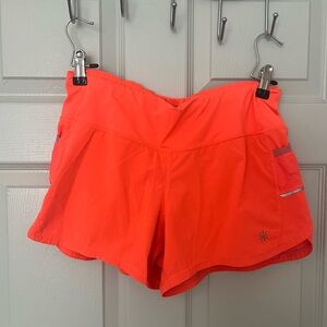 Orange Athleta running shorts